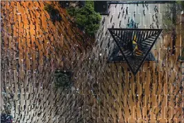  ?? ODED BALILTY — THE ASSOCIATED PRESS ?? In this Saturday photo, people maintain social distancing during a protest against Prime Minister Benjamin Netanyahu and government corruption at Rabin Square in Tel Aviv, Israel.