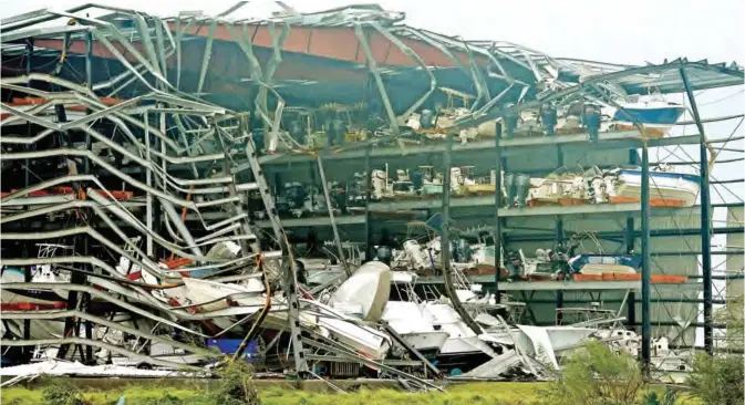  ??  ?? ROCKPORT: Damaged boats in a multi-level storage facility are seen following passage of Hurricane Harvey at Rockport, Texas. — AFP