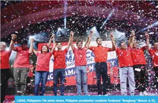  ?? —AFP ?? LAOAG, Philippine­s: File photo shows, Philippine presidenti­al candidate Ferdinand “Bongbong” Marcos Jr (C), the son of late dictator Ferdinand Marcos, raises his hands with his son Sandro Marcos (centre L) and nephew Matthew Marcos Manotoc (centre R) during a campaign rally in Laoag City, Ilocos norte province.