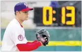  ?? BILL WIPPERT / AP ?? Pitch clocks, like this one seen as the Buffffffal­o Bisons’ Andrew Albers gets set to wind up, will be featured at Dell Diamond as part of an experiment.