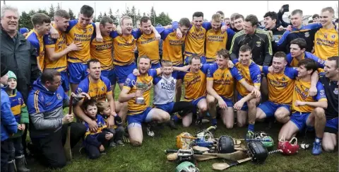  ??  ?? Gusserane captain Kenneth Cahill with his team-mates and mentors after the club bridged a 20-year gap in Clongeen on Saturday.