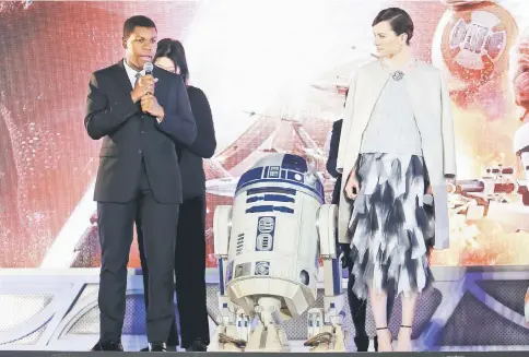  ??  ?? Cast members John Boyega (left) speaks next to Daisy Ridley during a red carpet fan event for their upcoming movie ‘Star Wars: The Force Awakens’ in Tokyo, Japan, Dec 10, 2015. — Reuters file photo