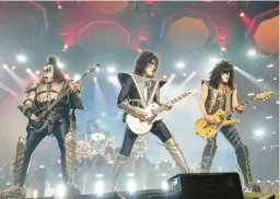  ?? EVAN AGOSTINI/INVISION ?? Gene Simmons, from left, Tommy Thayer and Paul Stanley of Kiss perform Dec. 2 in New York. The rock band has sold its catalog, brand name and IP.