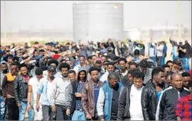  ?? Abir Sultan EPA/Shuttersto­ck ?? IN SOUTHERN Israel, asylum seekers march in a February protest over the detention of 18 migrants who were detained after refusing to leave the country.