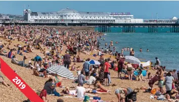  ??  ?? The packed scenes you would normally expect on Brighton beach on the first hot weekend