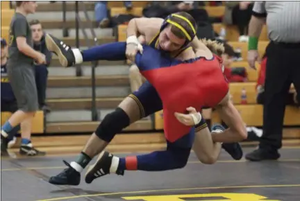  ?? JEN FORBUS — THE MORNING JOURNAL ?? North Ridgeville’s Jacob Dunstan wrestles Oberlin’s Robert Bouchonvil­le to the mat in the first-place bout of the 132-pound weight class at the J.B. Firestone Invitation­al on Dec. 15.