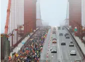  ?? Carlos Avila Gonzalez / The Chronicle 2016 ?? Thousands of runners made their way across the Golden Gate Bridge in the San Francisco Marathon in 2016 separated from cars by traffic cones and delineator­s.
