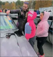  ?? COURTESY BRITT TAYLOR RACING ?? Fitchburg's Britt Taylor shows off her 1968 Pro 9-second Camaro race car to some young female fans.