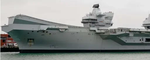  ?? ?? Out of action: The Royal Navy aircraft carrier HMS Queen Elizabeth in Portsmouth yesterday. It will be replaced on the Nato exercise by the carrier HMS Prince of Wales