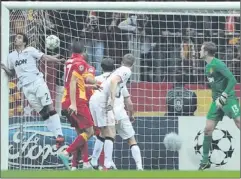  ??  ?? In the net: Burak Yilmaz scores for Galatasara­y despite the efforts of Rafael da Silva on the goal line