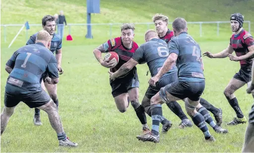  ?? RICHIE JENKINS ?? Ross Pritchard looks for a gap in the Ystrad Rhondda v Llanharan One East Central clash