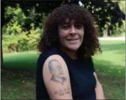  ??  ?? Barbara Quick outside her home shows off the tattoo of her husband Steven J. Quick she had done after his death in March of this year.