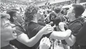  ?? COURTNEY HERGESHEIM­ER/COLUMBUS DISPATCH ?? Delaware Hayes fans and players celebrate their win over Olentangy Orange in the Division I regional final.