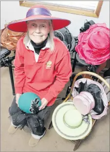  ?? SUEANN MUSICK/THE NEWS ?? Sandy Guadagni sits with a small portion of the hats in her collection. She will be picking out a favourite for her Hats On! event at 135 Provost St., New Glasgow, where people can drop by throughout Saturday, starting at 8 a.m., and watch the Royal...