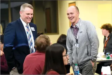  ?? NWA Democrat-Gazette/FLIP PUTTHOFF ?? William Felts (left) and Todd Sisson, both teachers at New Technology High School, chat Wednesday with residents at the Community in Action meeting in Rogers.