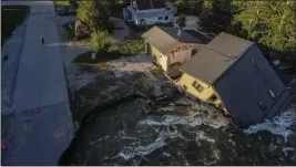  ?? DAVID GOLDMAN — THE ASSOCIATED PRESS FILE ?? A house sits in Rock Creek after floodwater­s washed away a road and a bridge in Red Lodge, Mont., on June 15.