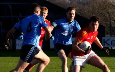  ??  ?? Midfielder Liam Ryan under pressure from Niall McMahon (4) and Pádraig McKeever (15).