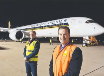  ?? Pictures: Kevin Farmer ?? FIRST FLIGHT: Wellcamp Airport general manager Robert Kasch (left) and TSBE Food Leaders Australia general manager Bruce McConnel with the Singapore Airlines plane.