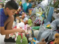  ?? ERIC GAY/AP ?? Brad Fowler, of San Antonio, lights candles at a memorial dedicated to the victims of the recent mass shooting at Robb Elementary School in Uvalde,
Texas.