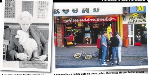  ?? Pictures: George Wilson ?? A woman and her trusty companion enjoying the bingo ground arcades, their bikes thrown to the
A group of boys huddle outside the