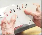  ?? Hearst CT Media file photo ?? A player looks over her hand in a Fairfield County Duplicate Bridge match at the YWCA in Greenwich in 2019.