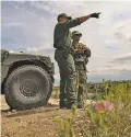  ?? NEW YORK TIMES FILE PHOTO ?? A Border Patrol officer talks with a member of the Texas National Guard mobilized to the border in April along the Rio Grande in Starr County, Texas.