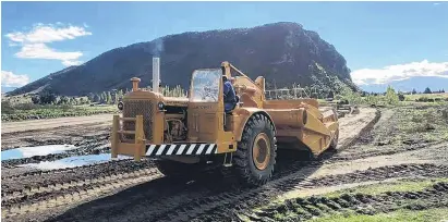  ?? PHOTO: SUPPLIED ?? Lake Hawea’s Kevin Cappell uses a CAT DW21 scraper to prepare the site at Three Parks for this weekend’s Wheels at Wanaka event.