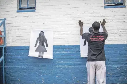  ?? Photo: Gulshan KHAN/AFP ?? Safer environmen­t: Instructor Den Manda puts up charts during a session with NGO Action Breaks Silence. New, harsher sanctions for sexual abuse by teachers will better protect children.