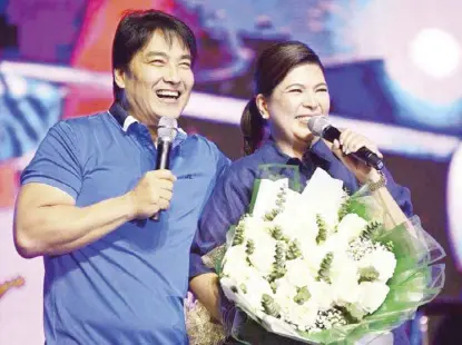  ?? ?? Cavite Second District Rep. Lani Mercado Revilla is joined by husband, Sen. Bong Revilla, onstage during the free musical concert to mark her 56th birthday (April 13).