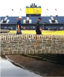  ?? THE ASSOCIATED PRESS ?? Jordan Spieth, left, and Justin Thomas walk toward the 18th green during a practice round Tuesday for the 147th Open Championsh­ip at the Carnoustie golf club in Scotland.