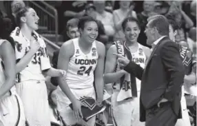  ??  ?? Connecticu­t coach Geno Auriemma jokes with, from left, Katie Lou Samuelson, Napheesa Collier and Gabby Williams as the clock winds down Monday in Bridgeport, Conn. Jessica Hill, The Associated Press