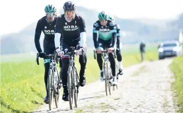  ??  ?? Slovakia’s cyclist of Bora team Peter Sagan (second left) rides with his teammates on cobbleston­e in Haveluy, near Wallers, northern France during a reconnaiss­ance ride ahead of the Paris-Roubaix road race. — AFP photo