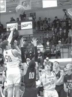  ??  ?? At left: Dylon Baum of Broken Bow puts up a hook shot against Wood River on Jan. 15. He finished the contest with six points and six rebounds on the inside.