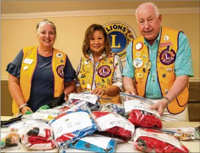  ??  ?? Lions Club members Missy Braden (from left), Doreen Stallworth and Richard Brown fill “PJ Packs” to donate to children’s hospitals for patients who have an unexpected need. Stallworth came up with the service project for the Lions.