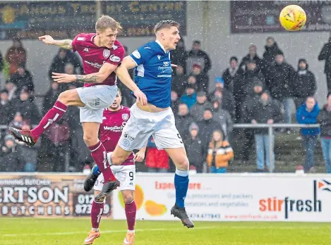  ?? Pictures: SNS. ?? David Gold rises above Doonhamers defender Michael Ledger to head home Arbroath’s opener.