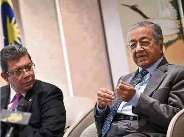  ?? — Bernama ?? Advantageo­us move: Dr Mahathir speaking to reporters at the press conference in Beijing. Looking on is Foreign Minister Datuk Saifuddin Abdullah.