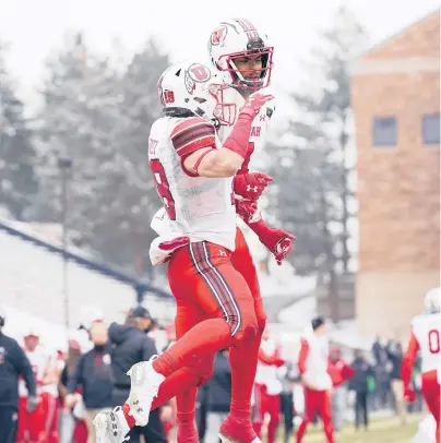  ?? DAVID ZALUBOWSKI/AP ?? Utah WR Britain Covey, front, celebrates with Bryan Thompson after a TD catch in Saturday’s victory over Colorado.
