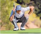  ?? JIM THOMPSON/JOURNAL ?? New Mexico’s Andre Garcia tries to read the green for his putt on the eighth hole at the UNM Championsh­ip Golf Course.