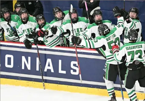  ?? Justin Guido photos/For the Post-Gazette ?? Pine-Richland celebrates a goal against Peters Township in a PIHL Class 3A Penguin Cup semifinal game Monday at the Robert Morris University Island Sports Center.