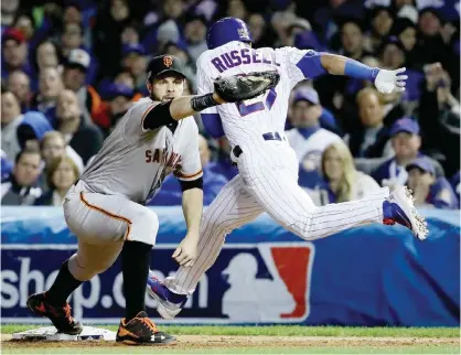  ?? —AFP ?? CHICAGO: Brandon Belt #9 of the San Francisco Giants forces out Addison Russell #27 of the Chicago Cubs at first base in the fifth inning at Wrigley Field on Saturday in Chicago, Illinois.