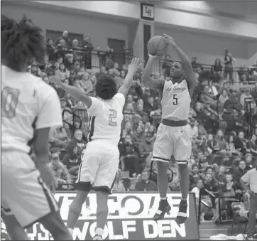  ?? The Sentinel-Record/Grace Brown ?? ON POINT: Hot Springs point guard J.J. Walker (5) attempts a shot against Lake Hamilton’s point guard, Mondo Watkins (2), Friday during the Trojans’ 83-65 loss at Wolf Arena in Pearcy.