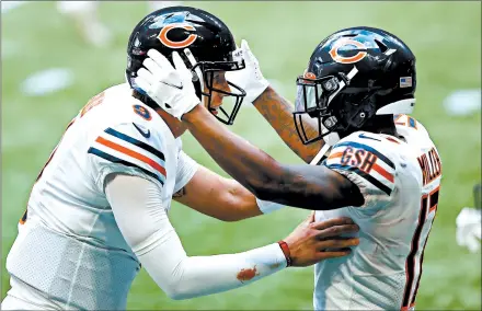  ??  ?? Nick Foles, left, and Anthony Miller celebrate scoring the game-winning touchdown with less than two minutes remaining. The Atlanta Falcons had a 26-10 lead going into the 4th quarter.