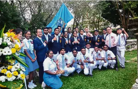  ??  ?? In memory: PFS senior assistant of administra­tion Ho Nean Chan (third from left) and school prefects at the thanksgivi­ng memorial service for Hutchings at the Protestant cemetery in Jalan Sultan Ahmad Shah.