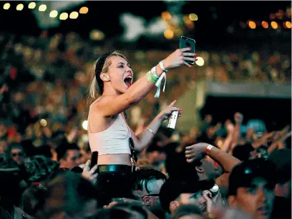  ??  ?? A woman rocks out at Rhythm and Vines last year. The organisers of the weekend festival want to be part of the change to more gender equality in the lineup but the festival has a predominan­tly young male audience.