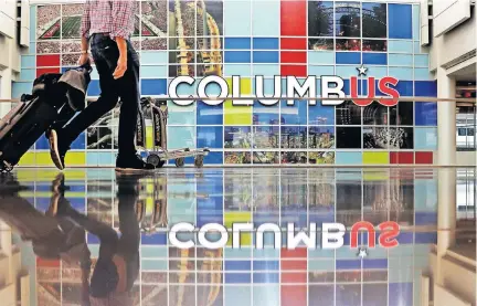  ?? [FRED SQUILLANTE/DISPATCH] ?? A traveler walks through the John Glenn Columbus Internatio­nal Airport terminal on Thursday.