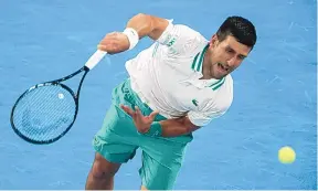  ?? HAMISH BLAIR/ASSOCIATED PRESS ?? Serbia’s Novak Djokovic serves to Russia’s Aslan Karatsev at the Australian Open Thursday in Melbourne. Djokovic is one win away from his ninth title at the major tournament.