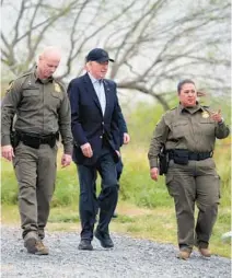  ?? EVAN VUCCI/AP ?? President Joe Biden looks over the southern border on Thursday in Brownsvill­e, Texas. Walking with Biden are Jason Owens, Chief, U.S. Border Patrol, left, and Gloria Chavez, Sector Chief, U.S. Border Patrol.