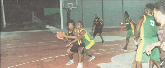  ?? ?? Part of the action in the ‘One Guyana’ Basketball League Playoffs between Kwakwani (green) and Mambas