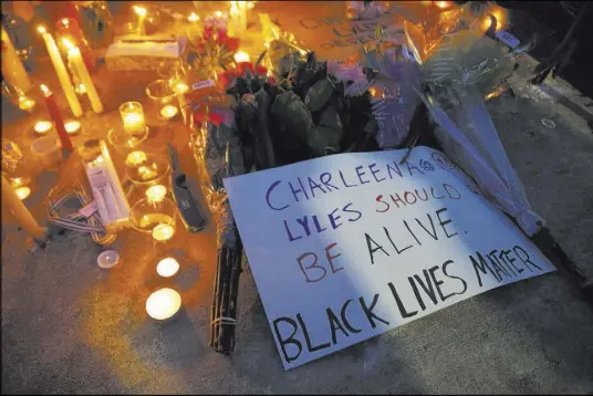  ?? The Associated Press ?? Vigil mementos were placed last week outside the Seattle apartment where 30-year-old Charleena Lyles lived. Two police officers responding to a burglary call shot Lyles, saying she came at them with a knife.