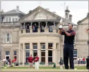  ?? ALASTAIR GRANT — THE ASSOCIATED PRESS ?? Tiger Woods holds the trophy as he stands in front of the clubhouse after winning the 2005 British Open on the Old Course at St. Andrews, Scotland.